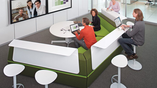 people in modern video conference meeting room with two large wall screens