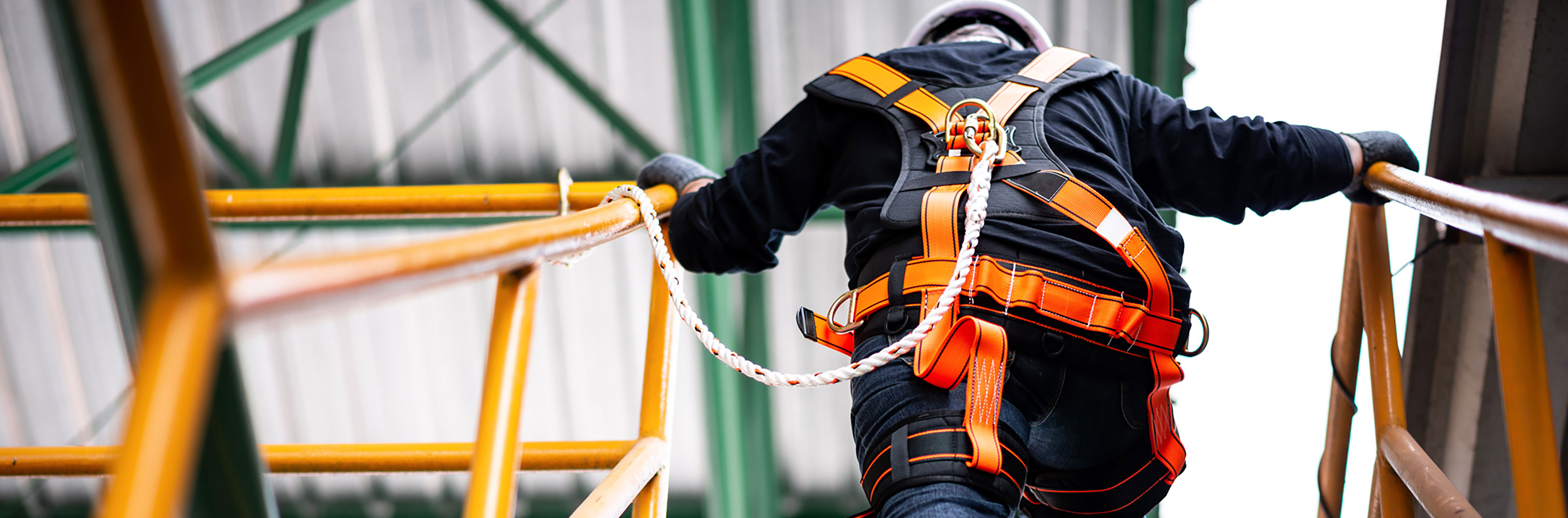 疯拍传媒 construction worker wearing safety harness and safety line working at a high location